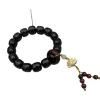 A dark brown wooden lotus-carved bracelet with small beaded tassels Item Picture